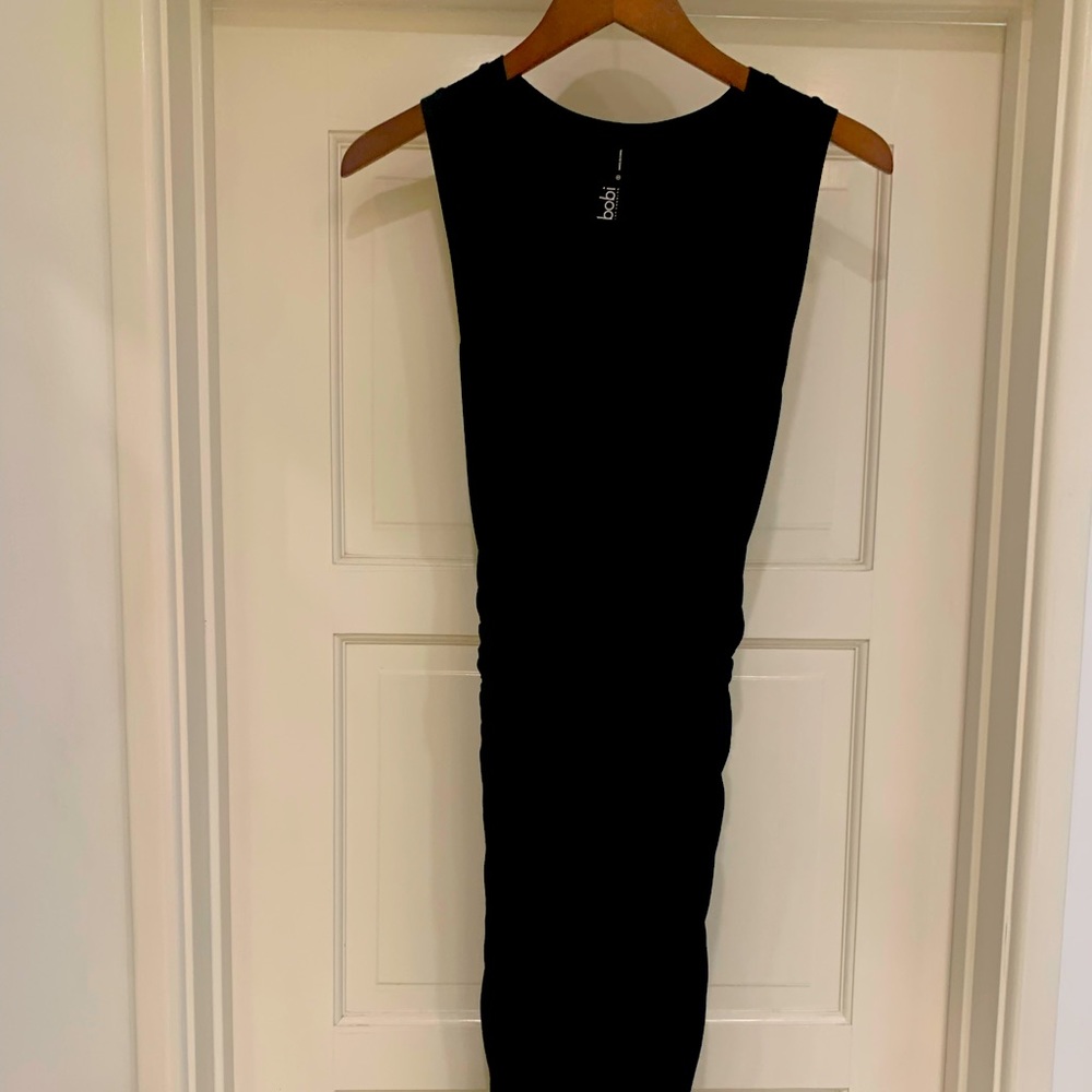 Mid length body con black dress.
